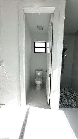 Bathroom with tile patterned floors and toilet