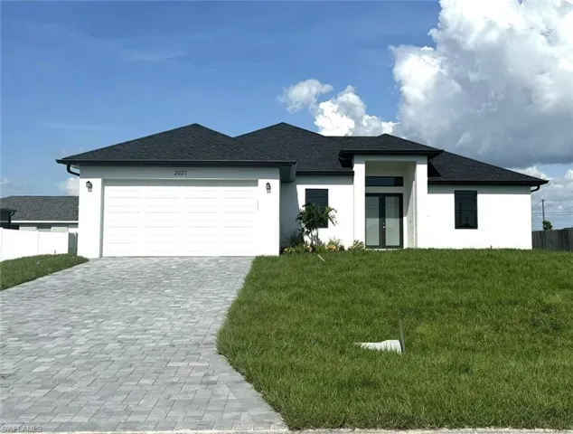 Prairie-style house with a garage and a front yard