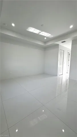 Unfurnished room featuring light tile patterned floors