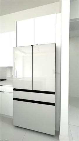 Room details with built in refrigerator and tile patterned flooring