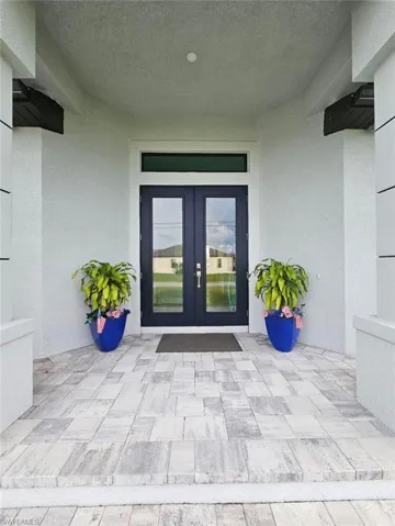 View of exterior entry with Impact Glass French doors