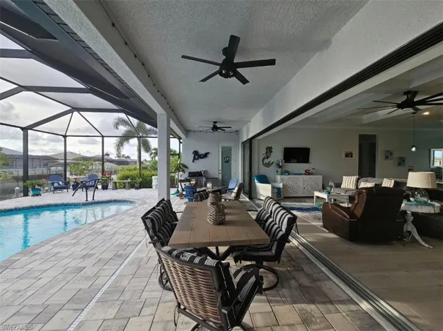 Covered Lanai with 10ft Ceilings, Pavers, 3 ceiling fans and 24ft of Pocketing Sliding Glass Doors.
