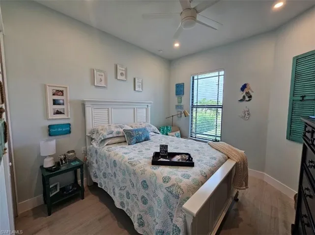 Guest Bedroom 3 featuring ceiling fan and light with Porcelain Plank flooring
