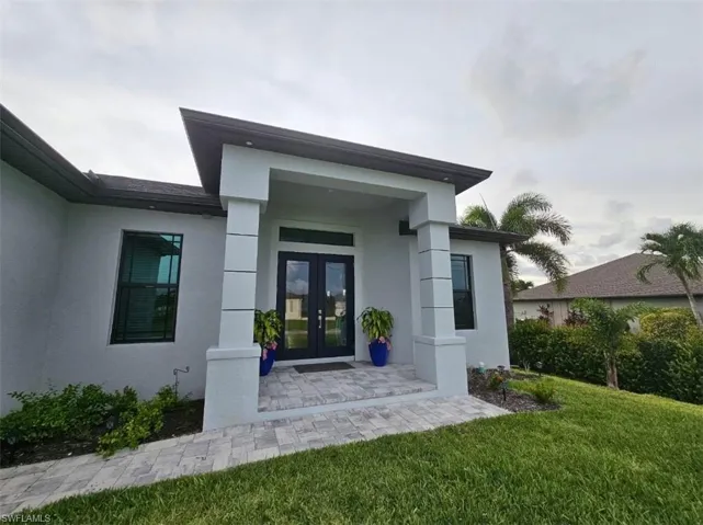 Entrance to property featuring Impact Glass French doors