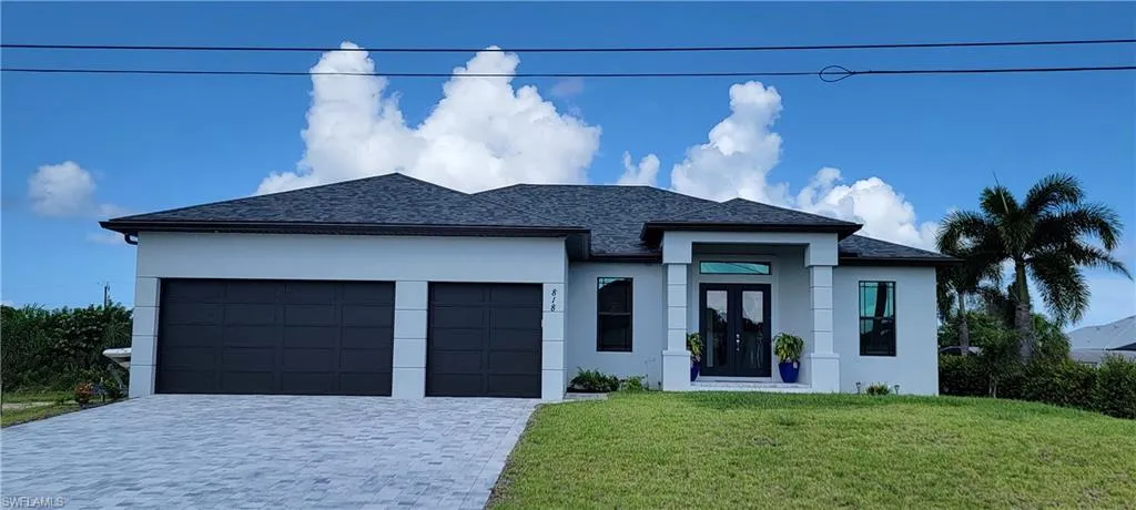 Contemporary home with a yard and a 3 car garage