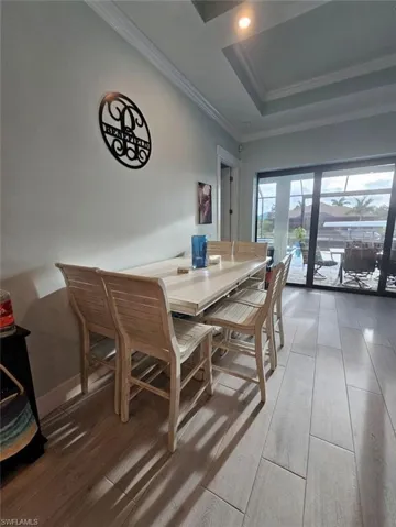 Dining space featuring a tray ceiling, crown molding,