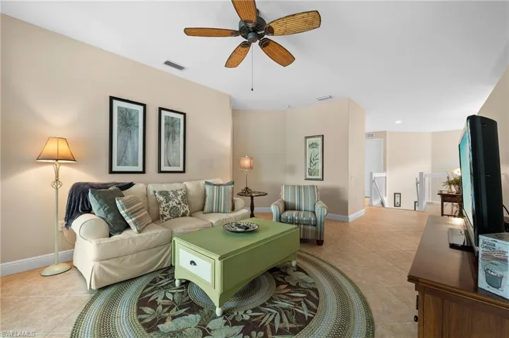 Living room featuring ceiling fan and light tile patterned floors