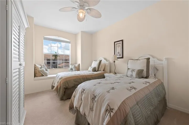 Carpeted bedroom with ceiling fan