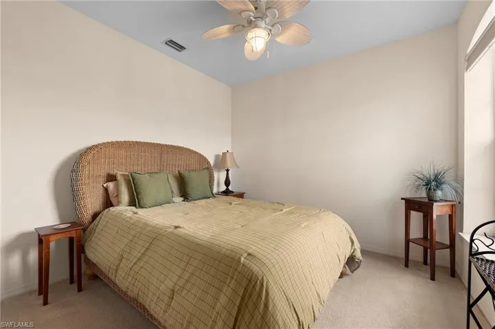 Bedroom featuring light colored carpet and ceiling fan
