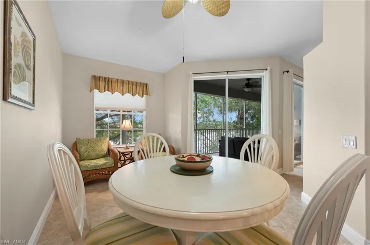 Dining room with ceiling fan and light tile patterned flooring