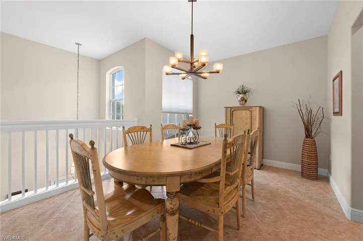 Dining area featuring light tile patterned floors and an inviting chandelier