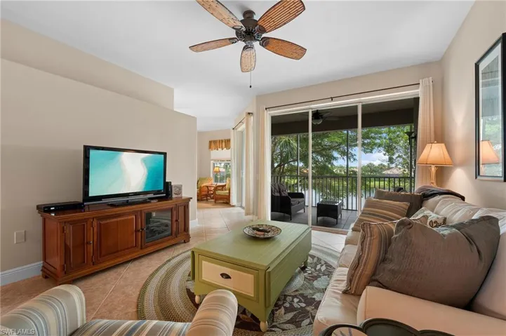 Living room featuring ceiling fan and light tile patterned floors