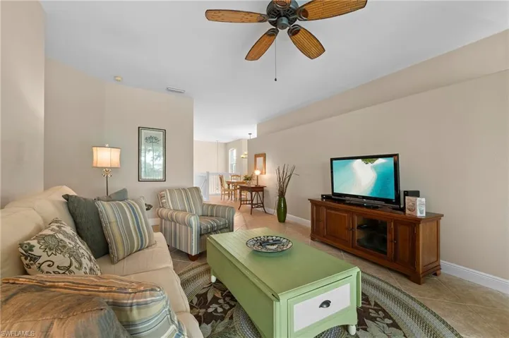 Living room featuring tile patterned flooring and ceiling fan