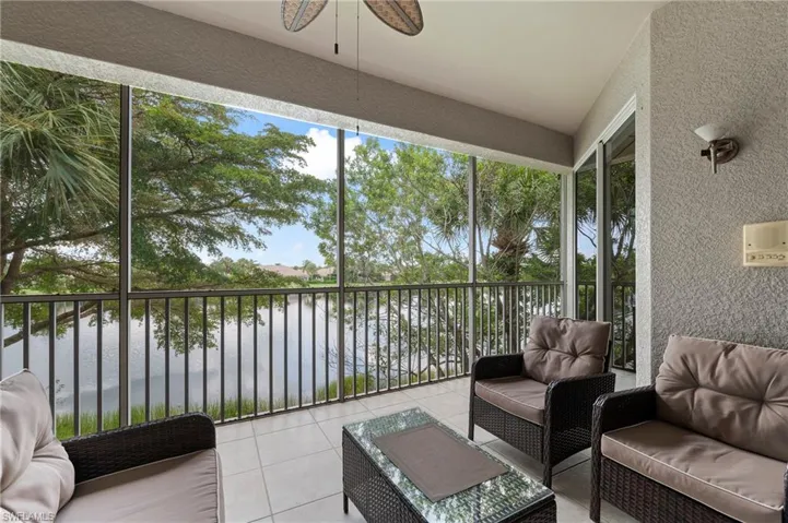 Sunroom featuring a water view and ceiling fan