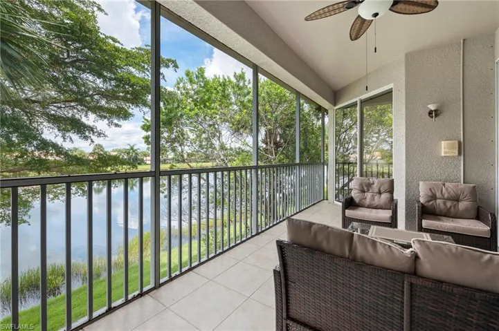 Sunroom / solarium featuring a water view, ceiling fan, and a wealth of natural light