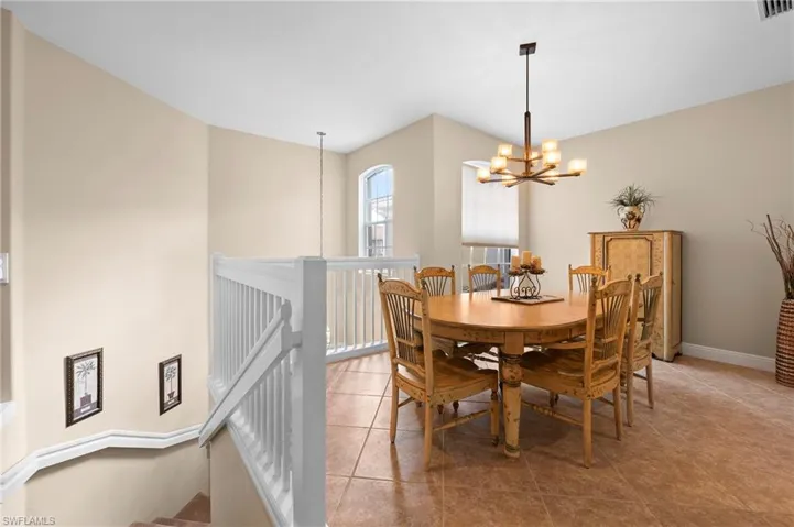 Dining room with a chandelier and tile patterned flooring