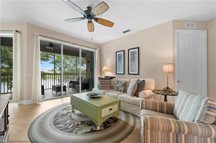 Tiled living room featuring ceiling fan