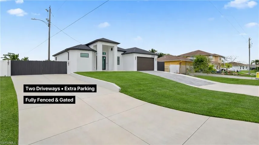 Prairie-style house featuring driveway, stucco siding, and a garage