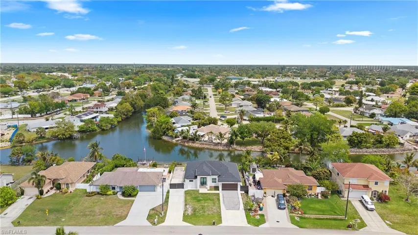 Aerial perspective of suburban area with a nearby body of water