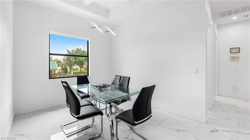 Dining room with light marble finish flooring and baseboards