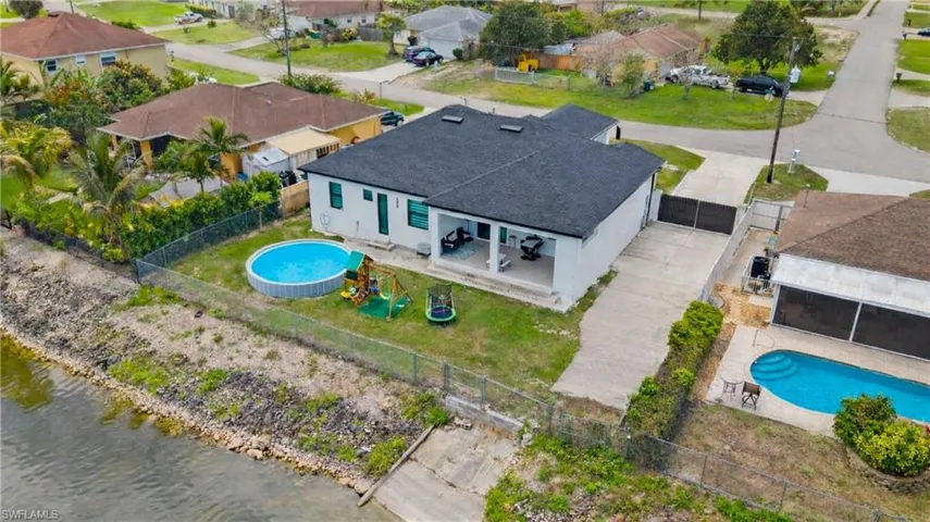 Aerial view of residential area featuring a pool area