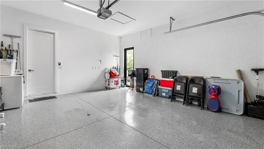 Garage featuring washer / clothes dryer and a garage door opener