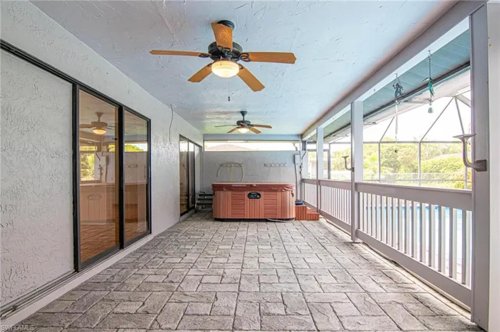 Brick pavered covered lanai area features your private hot tub!