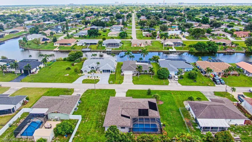 Aerial view looking East of houses across the street on fresh water canal!!
