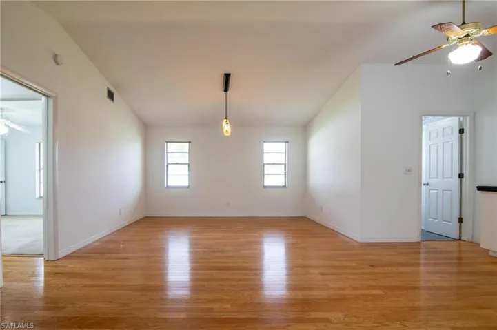 Long view of the family room with guest bedrooms/bath to the left and laundry room entrance to the right.