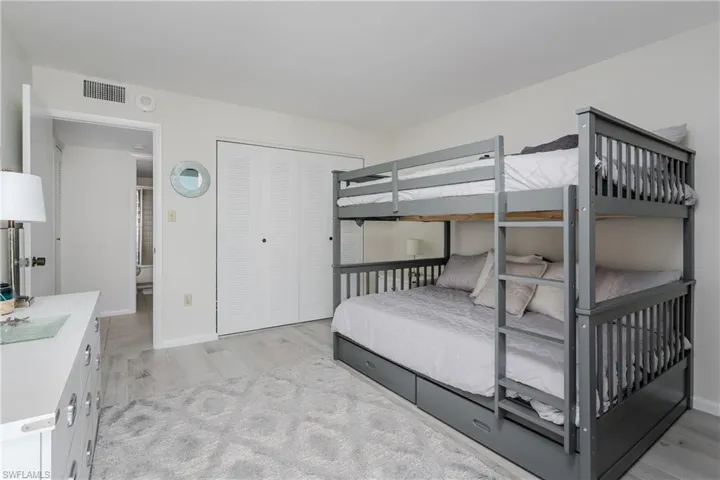 Bedroom featuring light hardwood / wood-style floors and a closet
