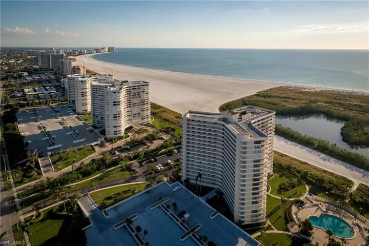 Birds eye view of property featuring a view of the beach and a water view