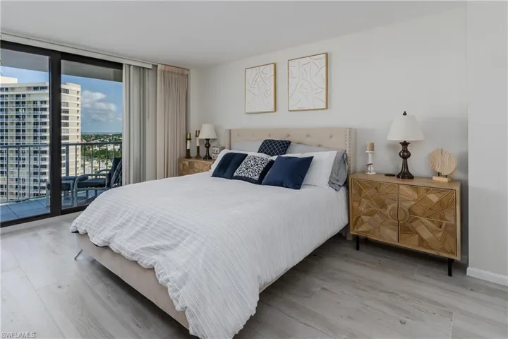 Bedroom with wood-type flooring and access to outside