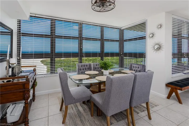 Dining room with light tile patterned floors and plenty of natural light