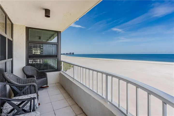 Balcony with a water view and a beach view