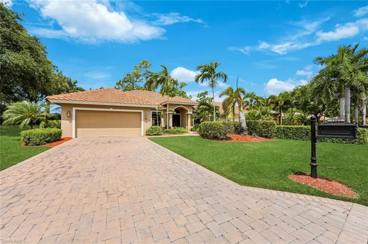 Front of the home showing the 2-car garage and paved driveway