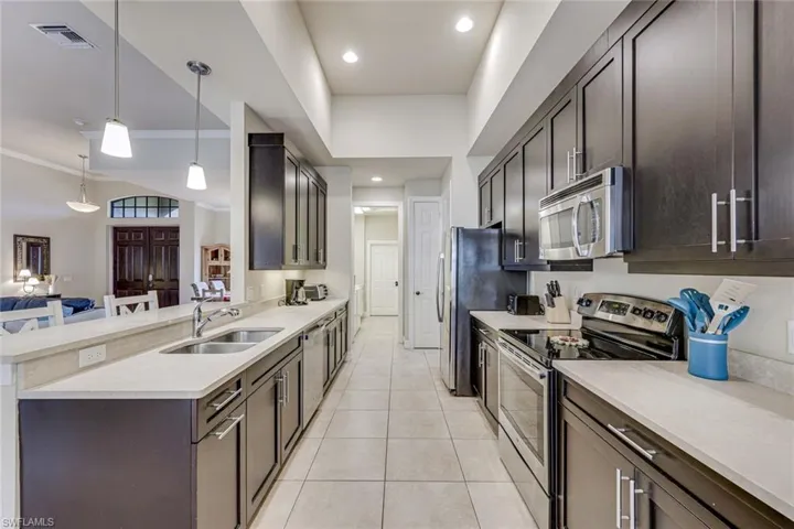 Well appointed kitchen with plenty of cabinetry, spacious countertops, and breakfast bar