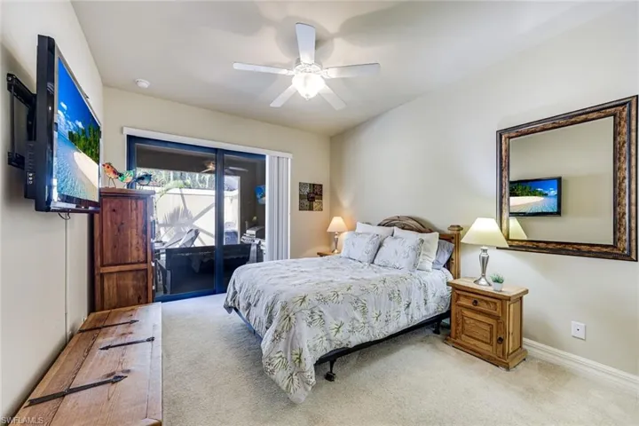 Guest bedroom with queen bed, private access to the lanai and pool