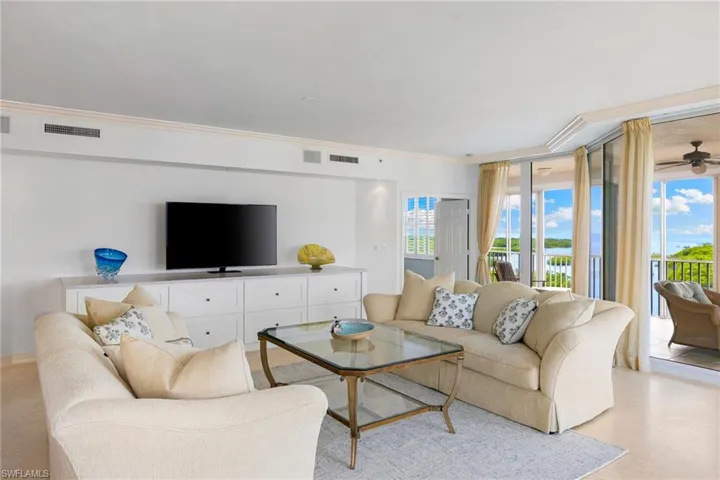 Living room with crown molding and ceiling fan