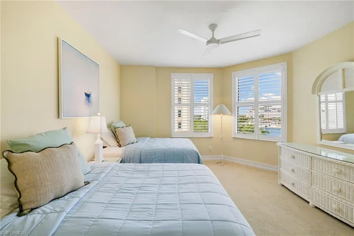 Bedroom featuring light colored carpet and a ceiling fan