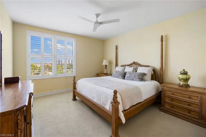 Bedroom featuring light carpet and ceiling fan