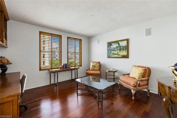 Sitting room featuring dark wood-style floors and an office area