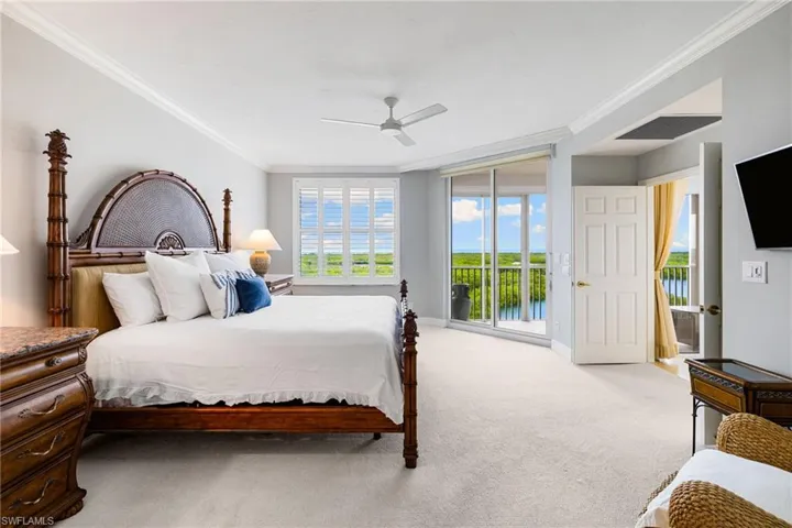 Carpeted bedroom featuring access to outside, ornamental molding, and a ceiling fan