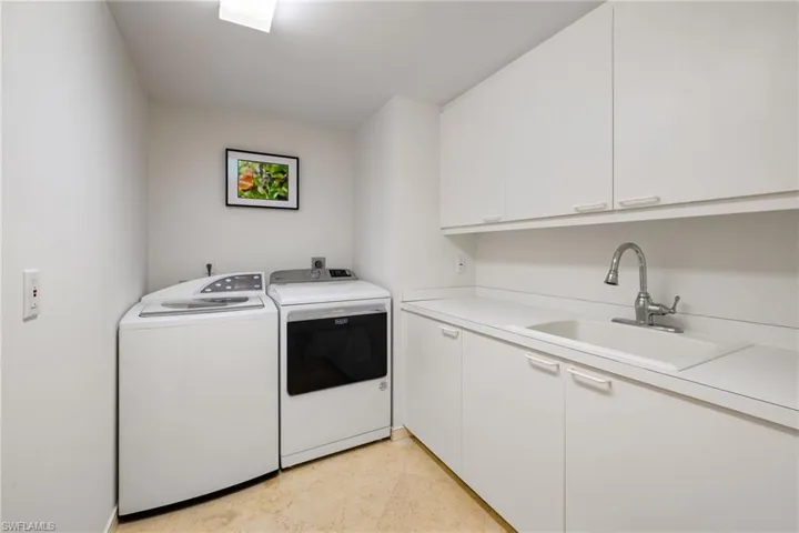 Laundry area with cabinet space and separate washer and dryer
