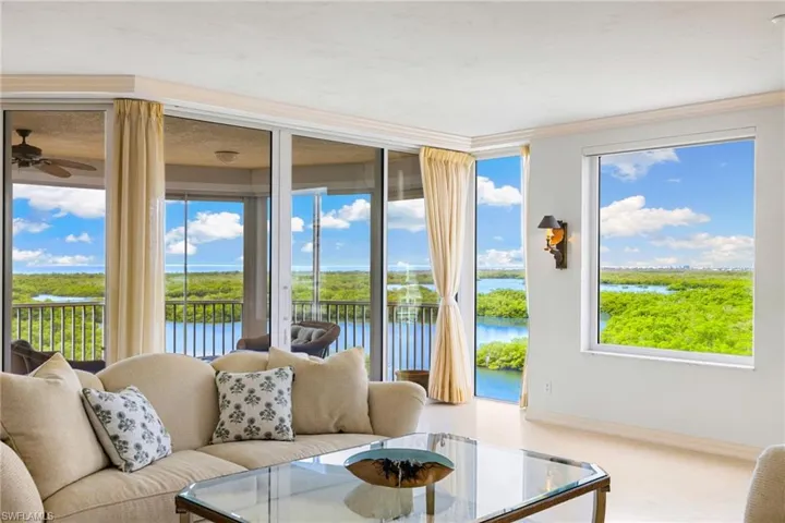 Carpeted living area featuring a water view