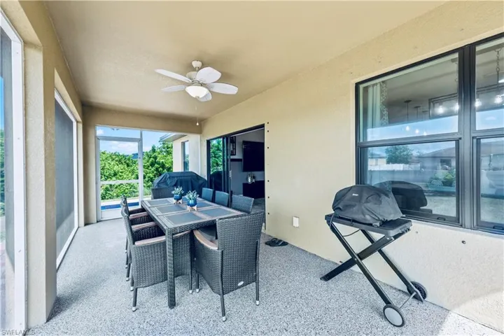 Sunroom featuring a ceiling fan