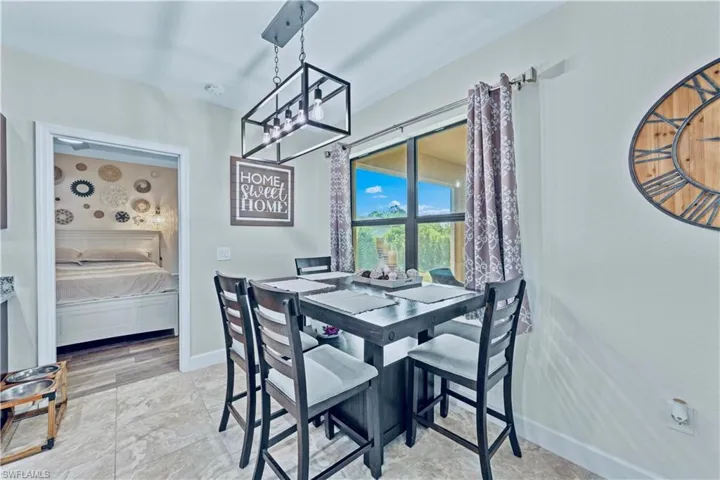 Dining room with baseboards and a notable chandelier
