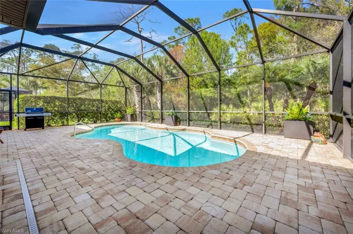 Another view of pool, showing portable grill.