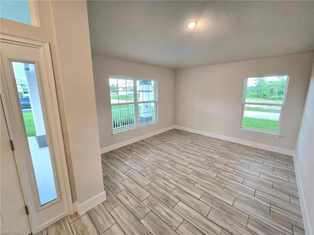 Unfurnished room featuring a textured ceiling
