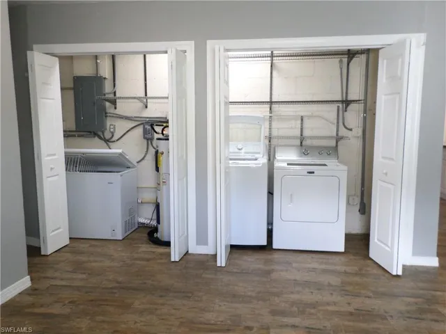 Laundry Area With An Extra Freezer included & Water Heater Area.