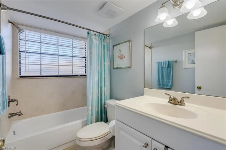 Bathroom with vanity and shower / bath combination with curtain
